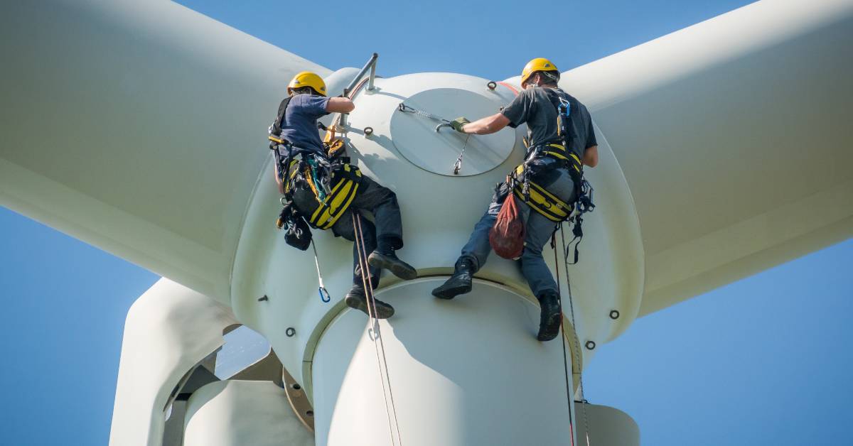 Construction workers assembling a wind turbine