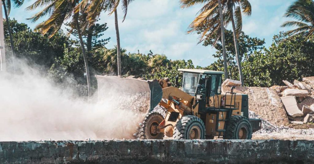 Wheel loader moving rubble in coastal environment
